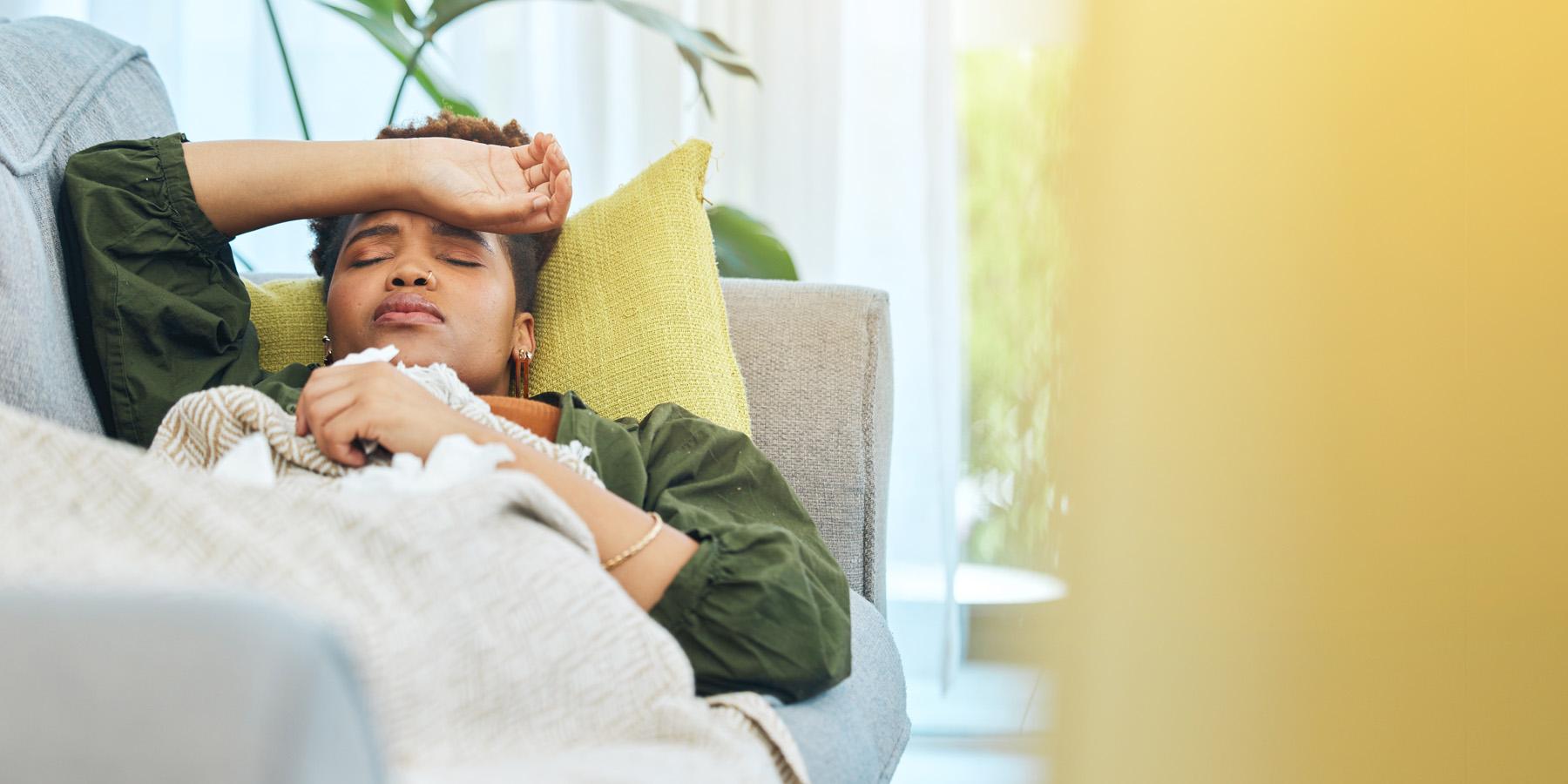 woman sick on couch