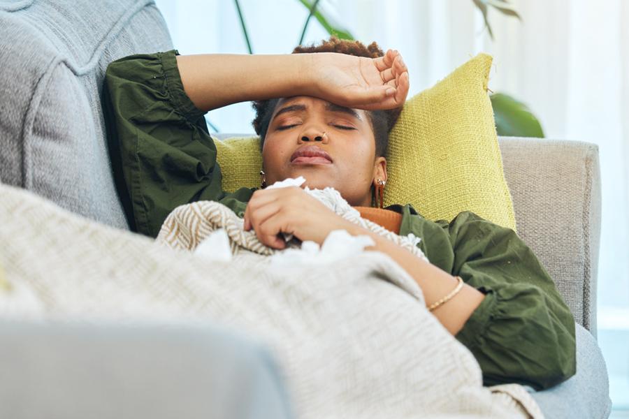 woman sick on couch